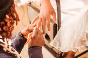 Nail technician carefully polishing a client fingers in a salon setting